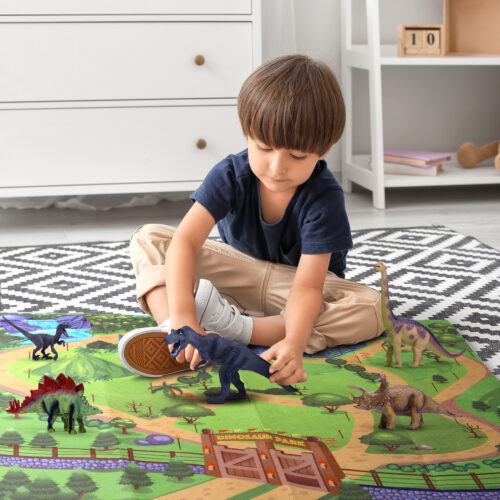 Little boy with autistic disorder playing with cubes at home